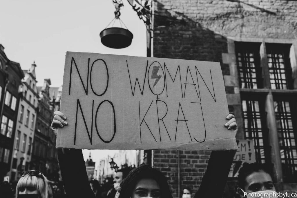 A protester holds up a sign, "NO WOMAN NO KRAJ" in a pro-choice protest.