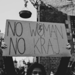 A protester holds up a sign, "NO WOMAN NO KRAJ" in a pro-choice protest.
