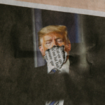 An photograph of Donald Trump in the newspaper, except his mouth has been ripped off.
