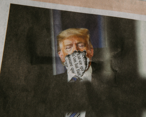 An photograph of Donald Trump in the newspaper, except his mouth has been ripped off.