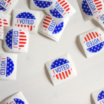 Photo of many colorful stickers that say "I Voted"