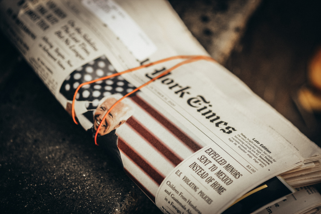 A folded up newspaper with a photo of Joe Biden and the headline "Expelled Minors Sent to Mexico Instead of Home"