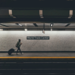 Two people walk through the New York City subway, at the World Trade Center stop.