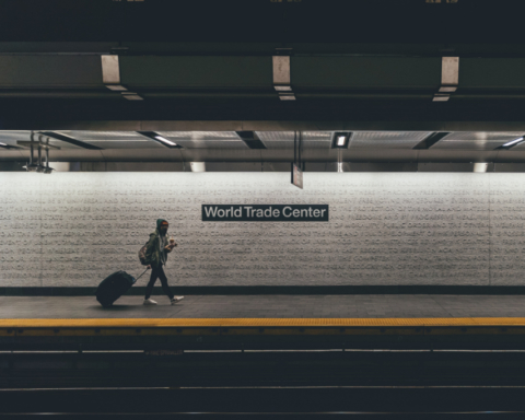 Two people walk through the New York City subway, at the World Trade Center stop.