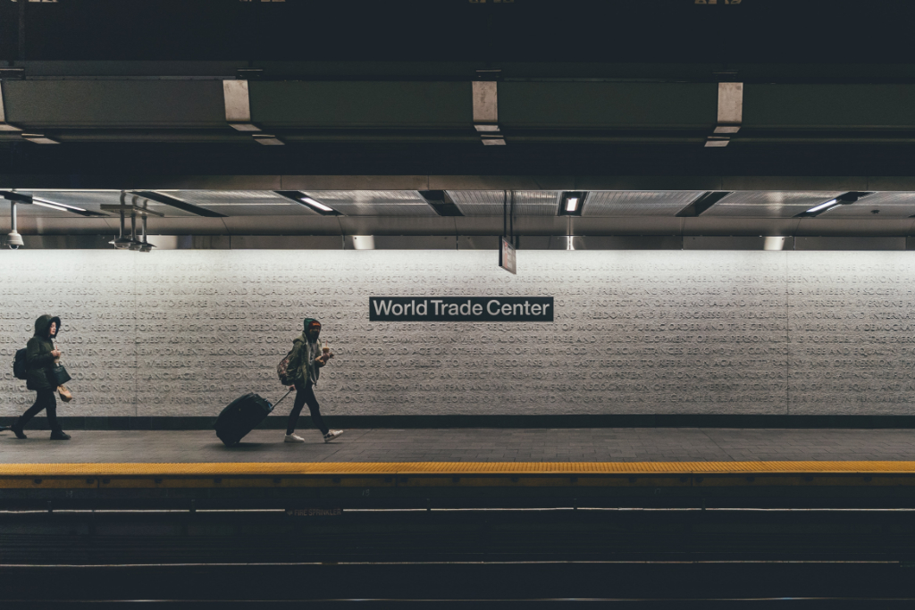 Two people walk through the New York City subway, at the World Trade Center stop.