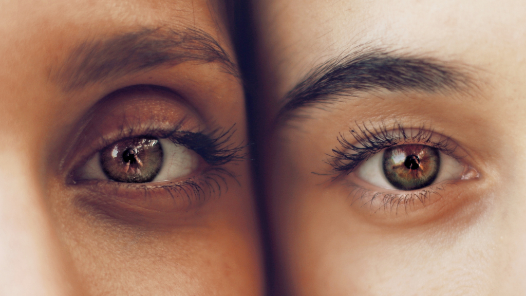 The eyes of two women of color look out.