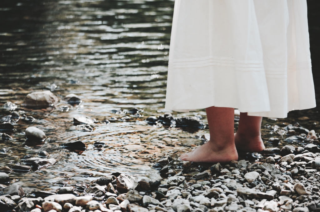 Bare feet on a stony bank