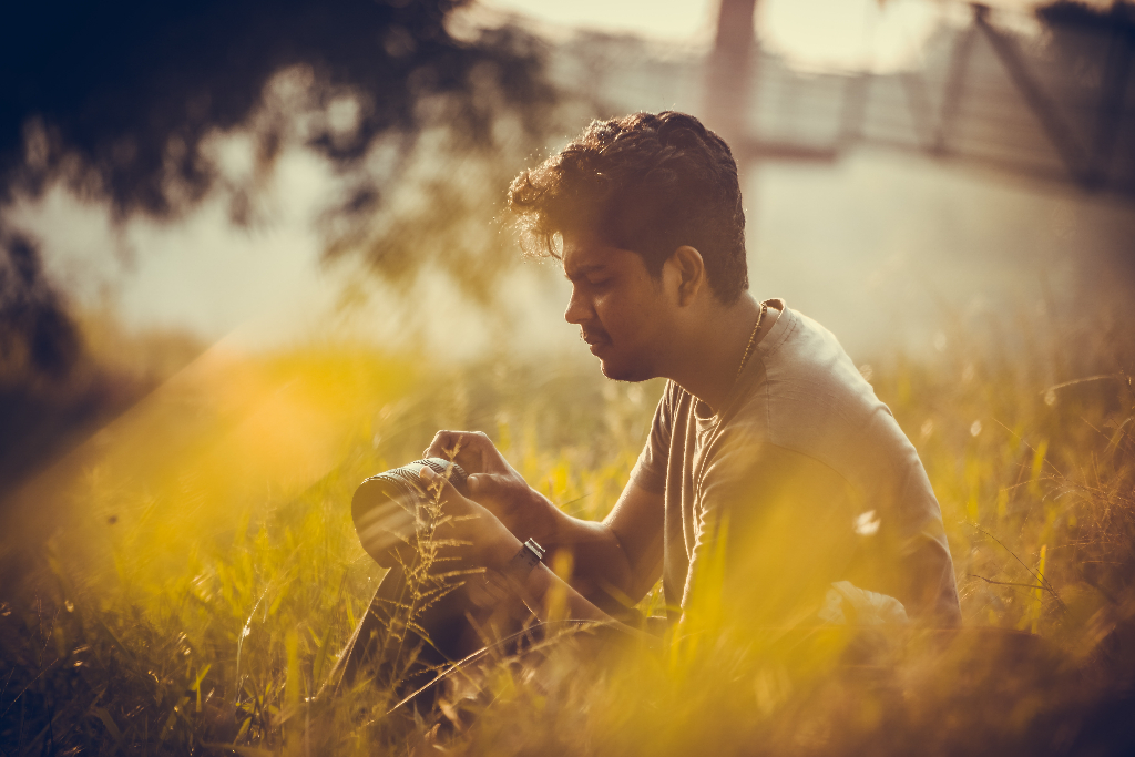 A man sits in a field in Kottayam, India.