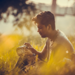 A man sits in a field in Kottayam, India.