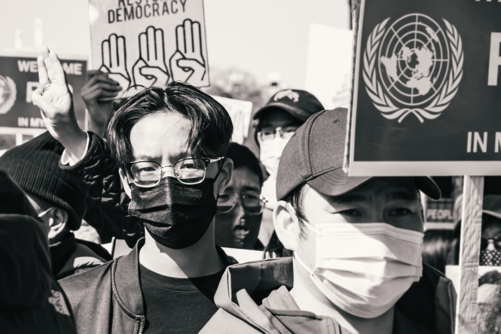 A protest in DC of the military coup in Myanmar features a crowd of young people with pro-democracy signs.