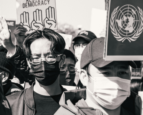 A protest in DC of the military coup in Myanmar features a crowd of young people with pro-democracy signs.