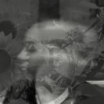 A black and white image of a woman's face superimposed with sunflowers.