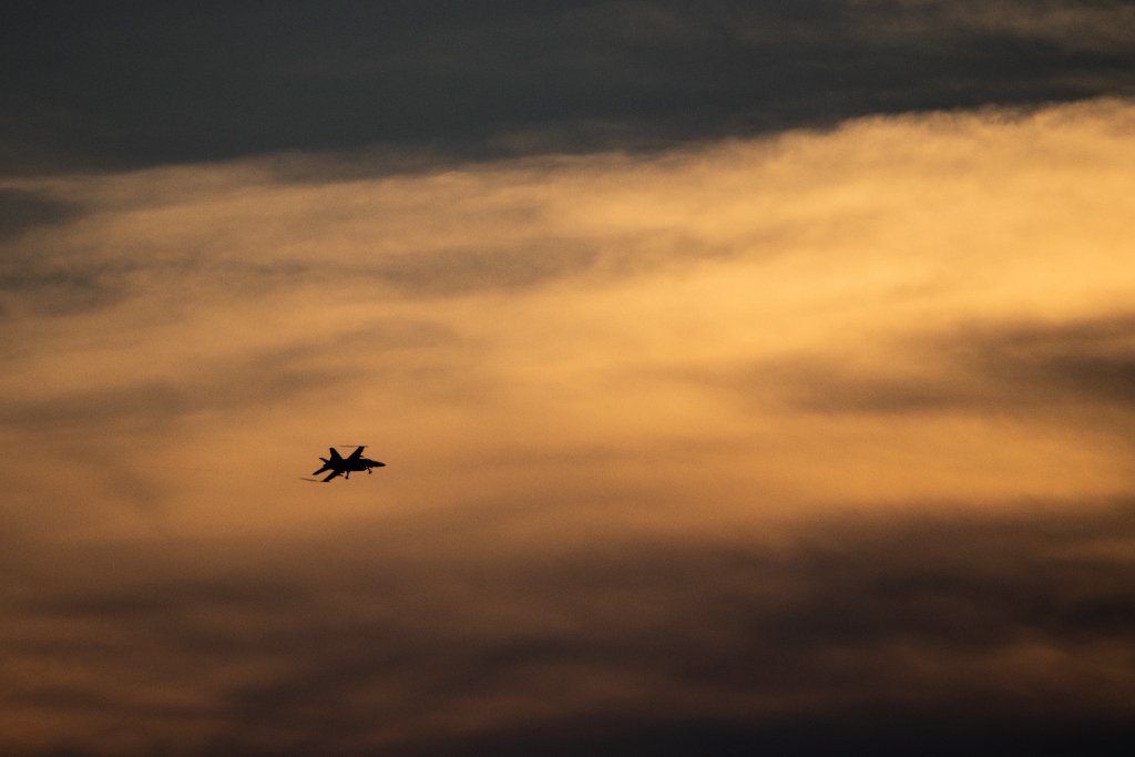 A military plane in the sunset.