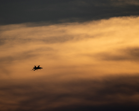 A military plane in the sunset.