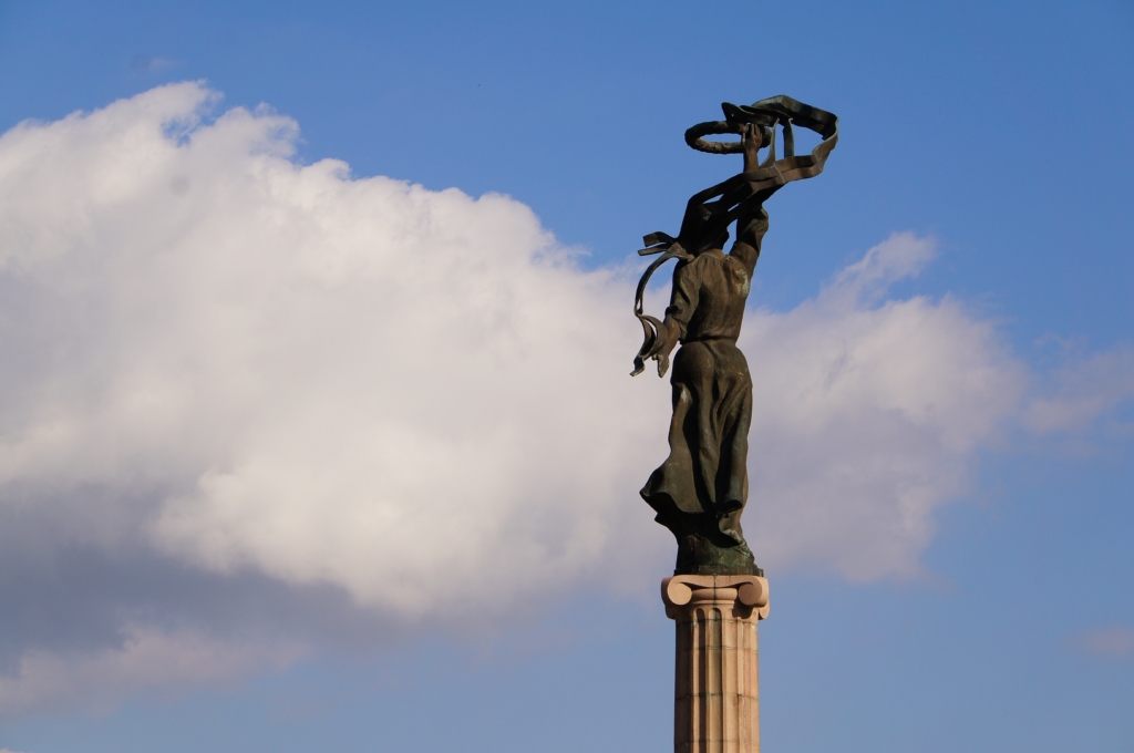 In this photograph taken in Ukraine, a sculpture lifts a ribbon to in the sky.