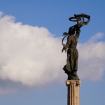 In this photograph taken in Ukraine, a sculpture lifts a ribbon to in the sky.