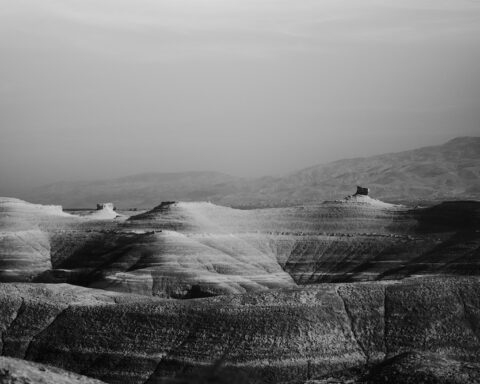 Stark black and white photograph of a bare mountain ridge in the West Bank of Palestine.